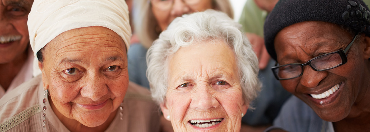 Smiling elderly individuals enjoying each other's company.